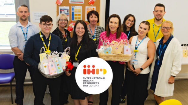 Carlene and colleagues smiling holding goodie bags