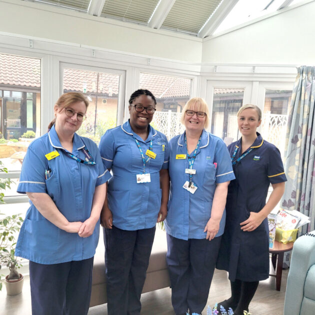 Four hospice nurses smiling